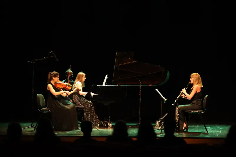 Re:Flexus Trio on stage under green lighting
